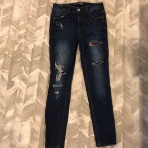 Dark wash jeans with plaid distressed detail